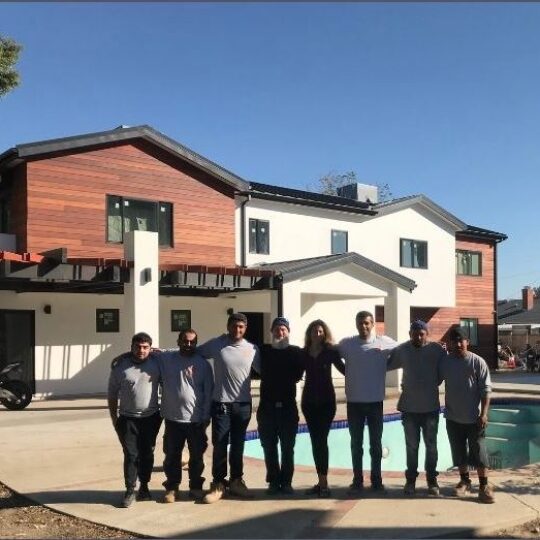 The Modline Builders team in front of a completed home
